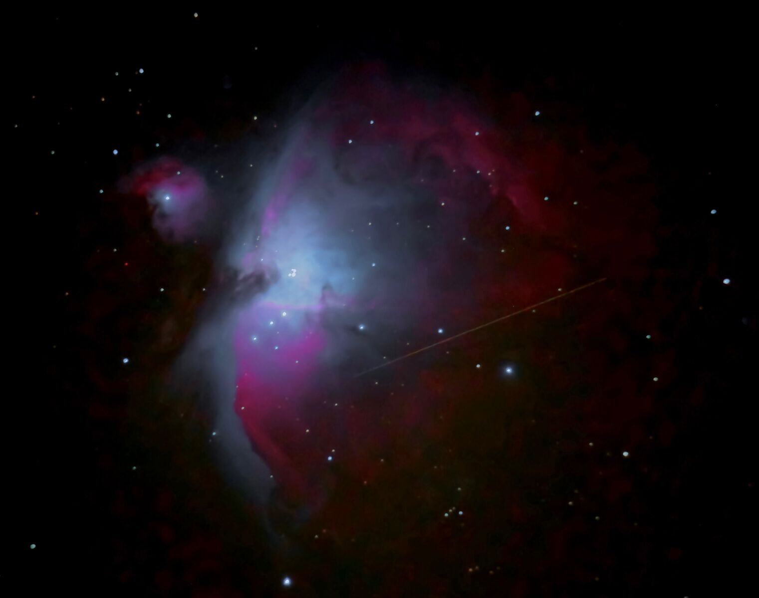 The Orion Nebula with either a meteor or a satellite streak