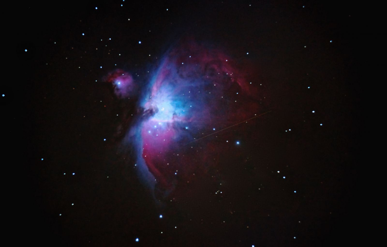 Orion Nebula with a satellite track.